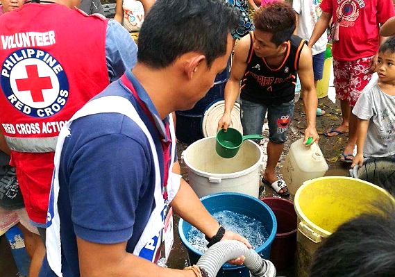 Philippine Red Cross personnel spend Christmas with families displaced by Vinta and Urduja